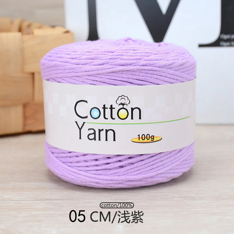 Purple 100% cotton yarn in a skein, labeled for knitting and crochet projects.