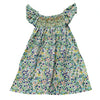 A girls floral smocked summer dress featuring a green and white print with ruffled sleeves.