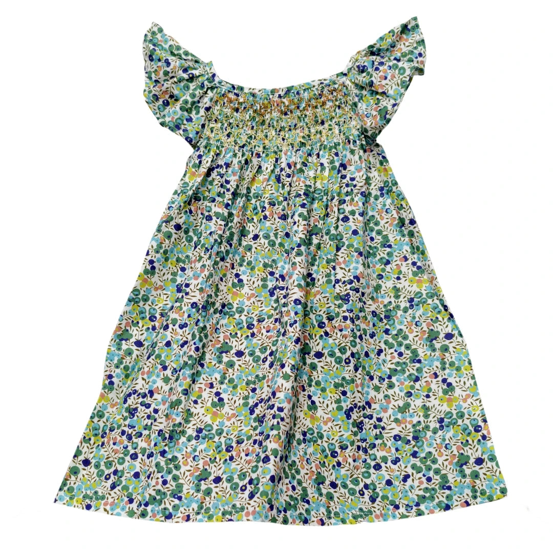 A girls floral smocked summer dress featuring a green and white print with ruffled sleeves.