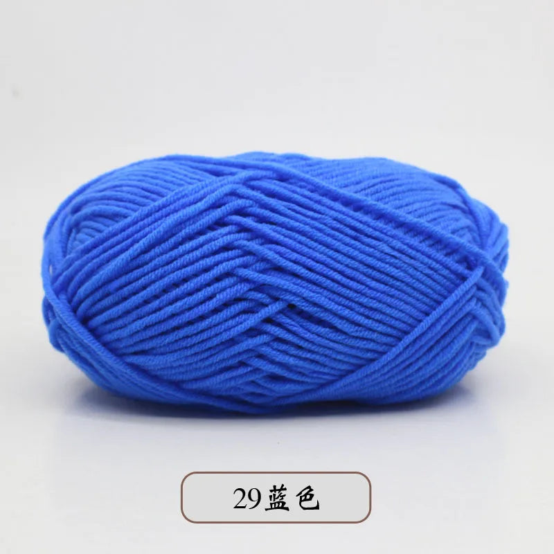 A ball of bright blue pre-dyed milk cotton yarn used for knitting and crochet.