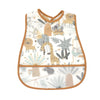 A white baby bib with a cartoon pattern featuring various animals like elephants, giraffes, and monkeys.