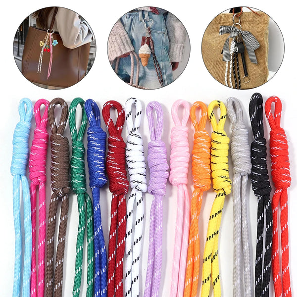A collection of colorful braided lanyards and keychains in various shades including pink, purple, green, orange, yellow, and 