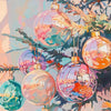 A close-up of colorful, iridescent glass ornaments hanging on pine branches.