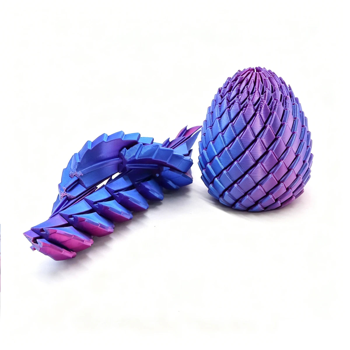 A purple and blue 3D printed expandable dragon egg fidget toy with a textured, segmented surface.