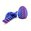 A purple and blue 3D printed expandable dragon egg fidget toy with a textured, segmented surface.