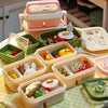 A collection of miniature doll picnic lunch boxes in various pastel colors and shapes arranged on a yellow checkered cloth.