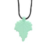 A light mint green silicone leaf pendant on a black cord necklace.