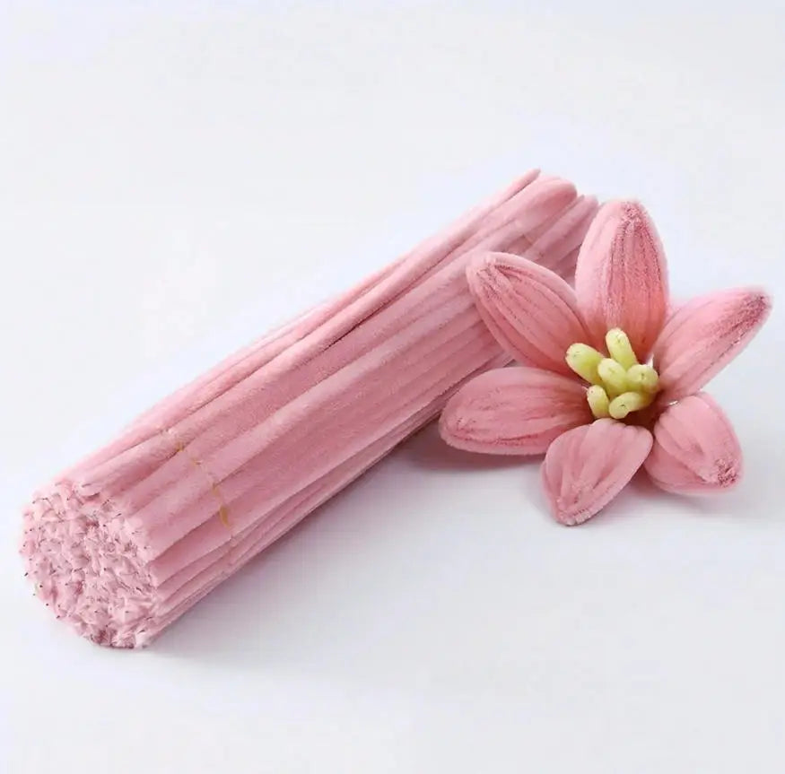A bundle of pink chenille craft pipe cleaners with a light pink hue.