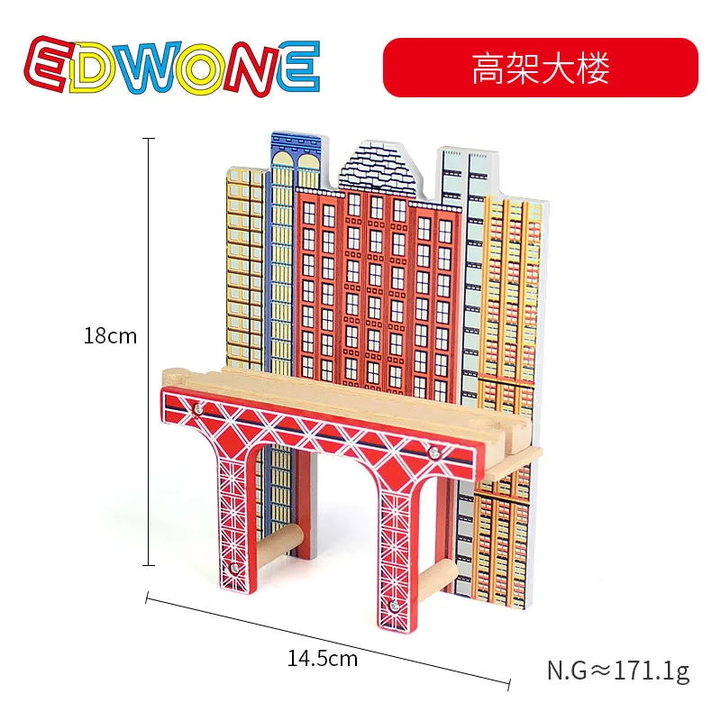 A wooden train track accessory set featuring buildings and structures, including an airport and gas station scene.