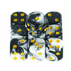 A set of ten mixed-color dice featuring black and white marbled patterns with yellow dots.