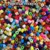 A close-up view of a large pile of assorted colored 5mm fuse beads for craft projects.