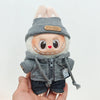A Labubu doll wearing a grey hoodie and hat with white ears, held in a hand.