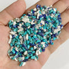 A handful of natural tumbled stone chips featuring various shades of turquoise blue and white.