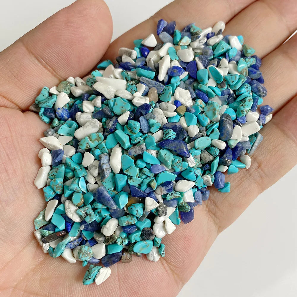 A handful of natural tumbled stone chips featuring various shades of turquoise blue and white.