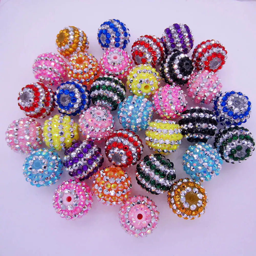 A collection of mixed two-tone striped resin beads in various colors and sizes for jewelry making