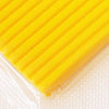 A bright yellow block of soft modeling clay is visible, packaged in clear plastic.