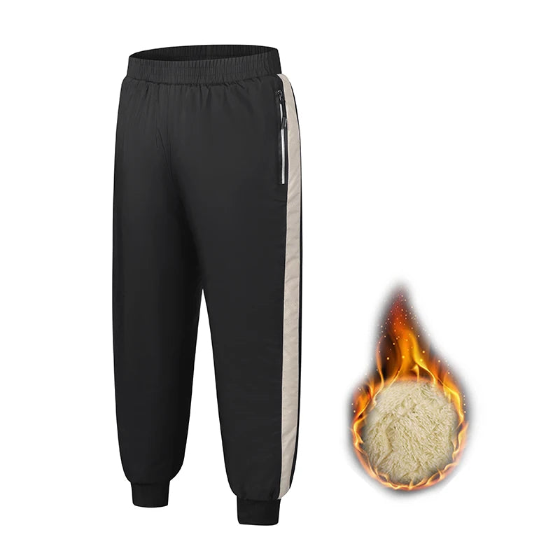 Black kids waterproof winter pants with a gray side stripe and a flame icon