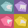 A set of wooden tangram puzzle cards in various pastel colors, including light blue, purple, and pink.
