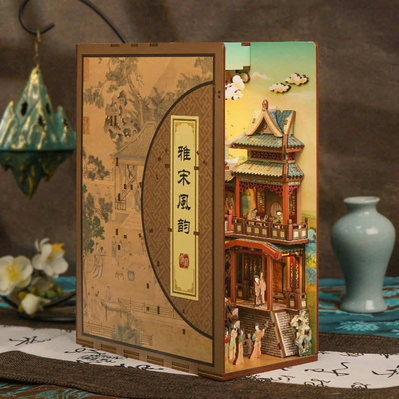 A DIY book nook kit featuring traditional Asian-inspired scenes with LED lighting and a dust cover.