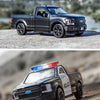 A black Ford F-150 SVT Raptor diecast model truck parked on a dirt road.
