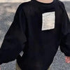 Black long sleeve cotton tee with white text on the chest