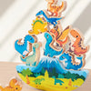 A stack of wooden dinosaur blocks in various colors and sizes, used as a Montessori balance toy for children.