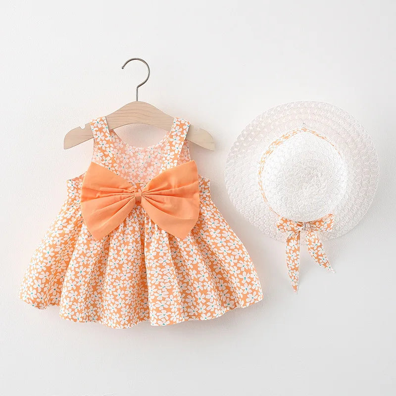 A baby girl summer dress and sunhat set featuring an orange floral print and bow details.