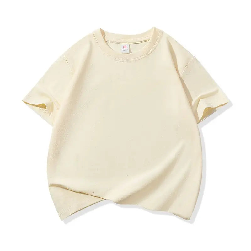 A light cream colored classic cotton crew neck t-shirt for kids shown flat lay.