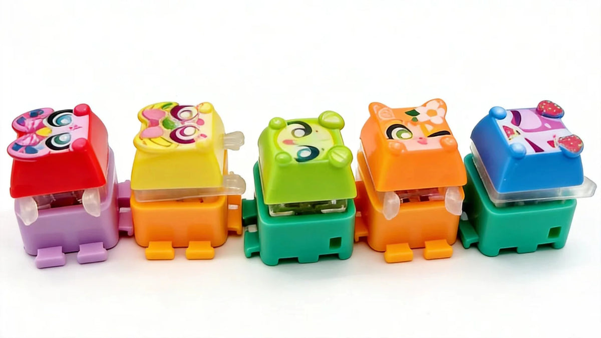 A row of colorful LED mechanical switch fidget keychains in various colors and designs.