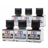A set of four glass bottles of Panel Line Accent Color enamel paint in brown, gray, and black with black caps.