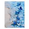 Blue butterflies swimming in clear ocean water near a sandy shore.