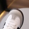Close-up view of a white and brown casual sneaker with white laces