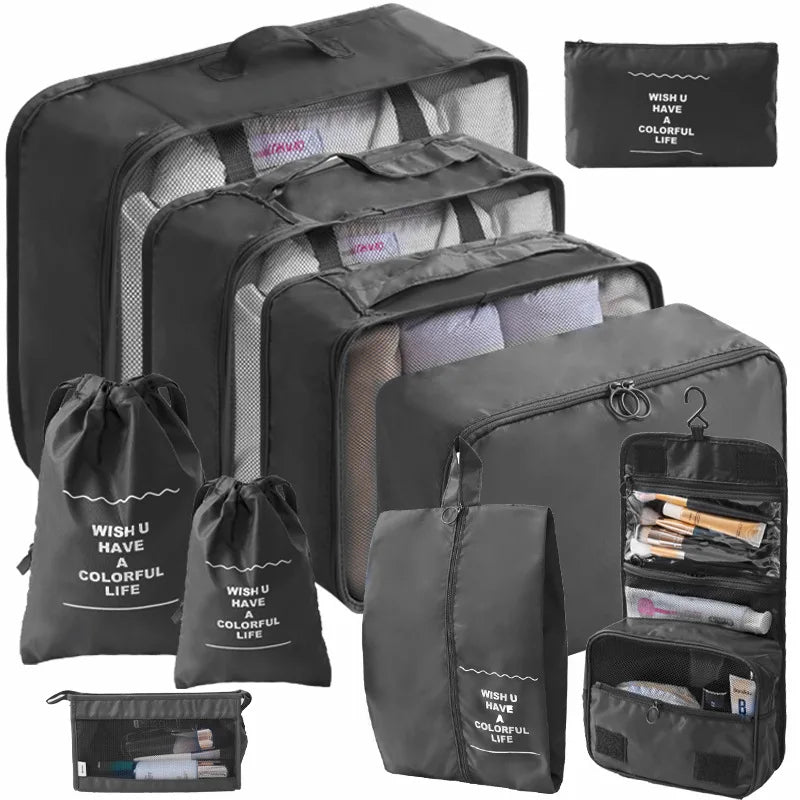 A set of black travel packing cubes and storage bags with a colorful life design.