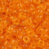 A pile of small, translucent orange pony beads for jewelry making and craft projects.