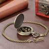 A steampunk dragon pocket watch dice case with seven mini dice displayed on a gold-toned chain.