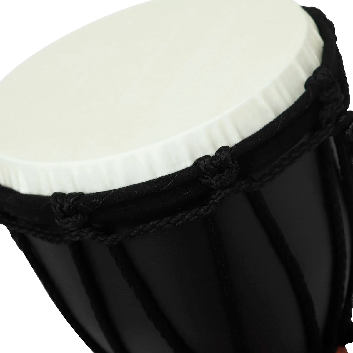 A close-up view of a black hand drum with a white top, showing the drum's texture and construction.