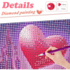 A hand paints a heart design on a diamond painting canvas featuring a starry night sky theme.