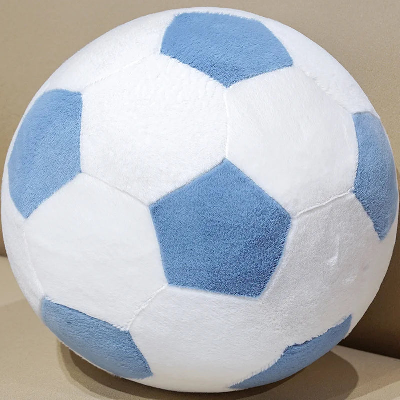 A white football plush pillow with light blue hexagonal panels.