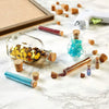 A set of natural wood tapered bottle and test tube stoppers, including a glass bottle filled with gold glitter and a small gl