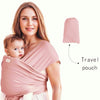 A woman wearing a pink knitted fabric baby carrier with a baby, and a separate pink travel pouch.