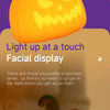 A glowing orange pumpkin LED night light is held in a hand, with bats and pumpkins decorating the background.