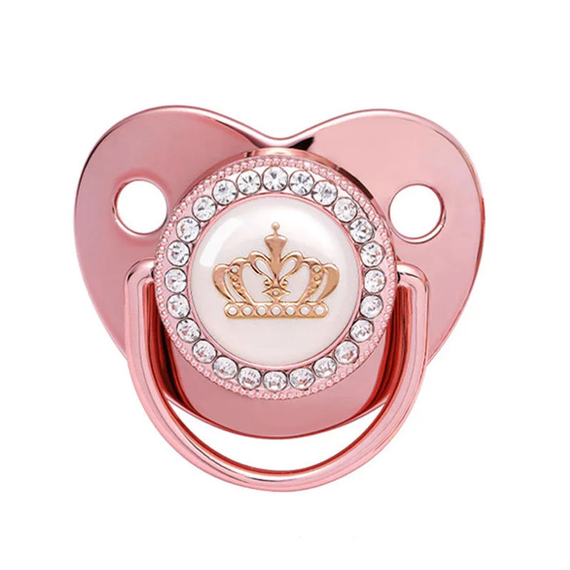 A rose gold crystal bling pacifier with a crown design for newborns.