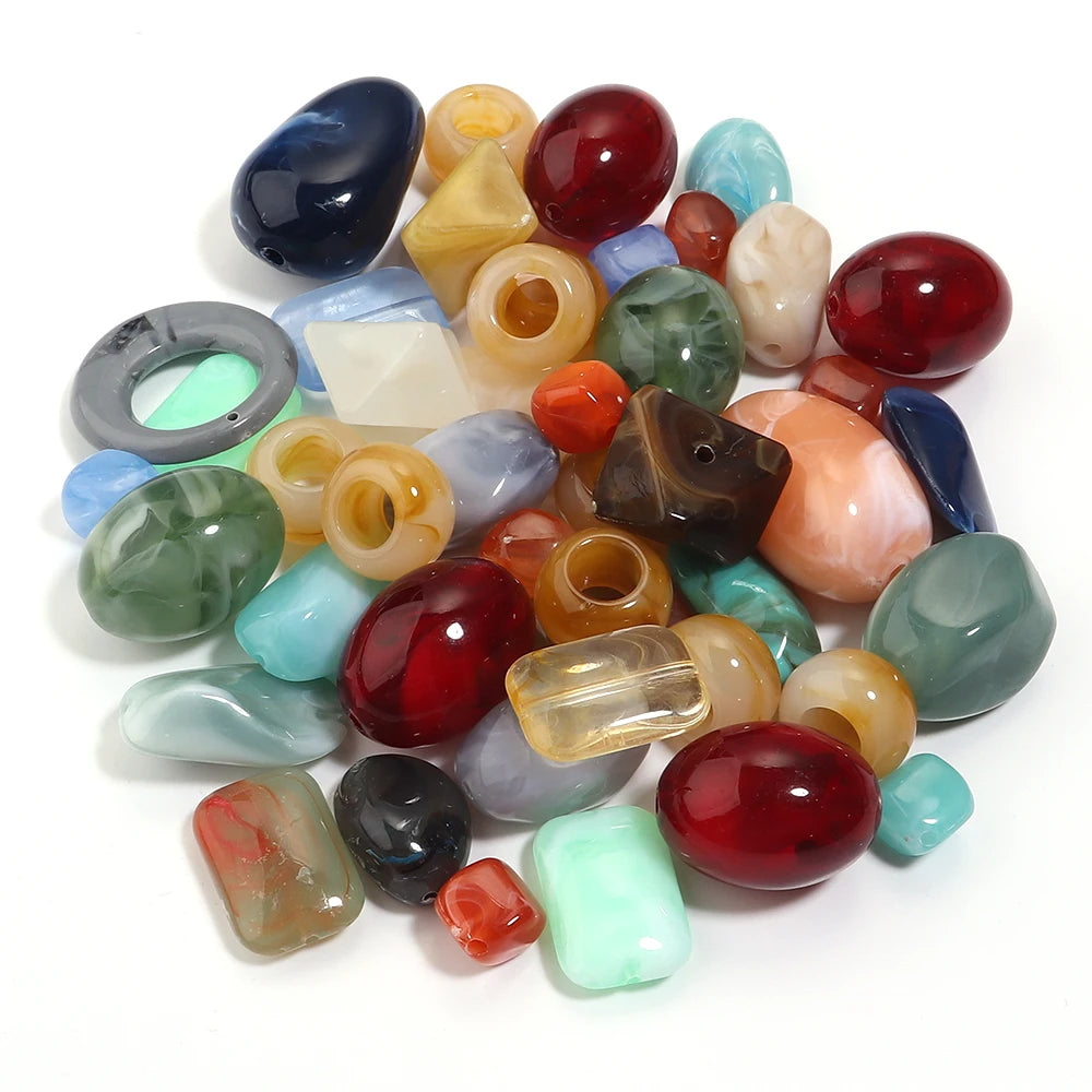 A collection of colorful acrylic beads in various shapes and colors for jewelry making