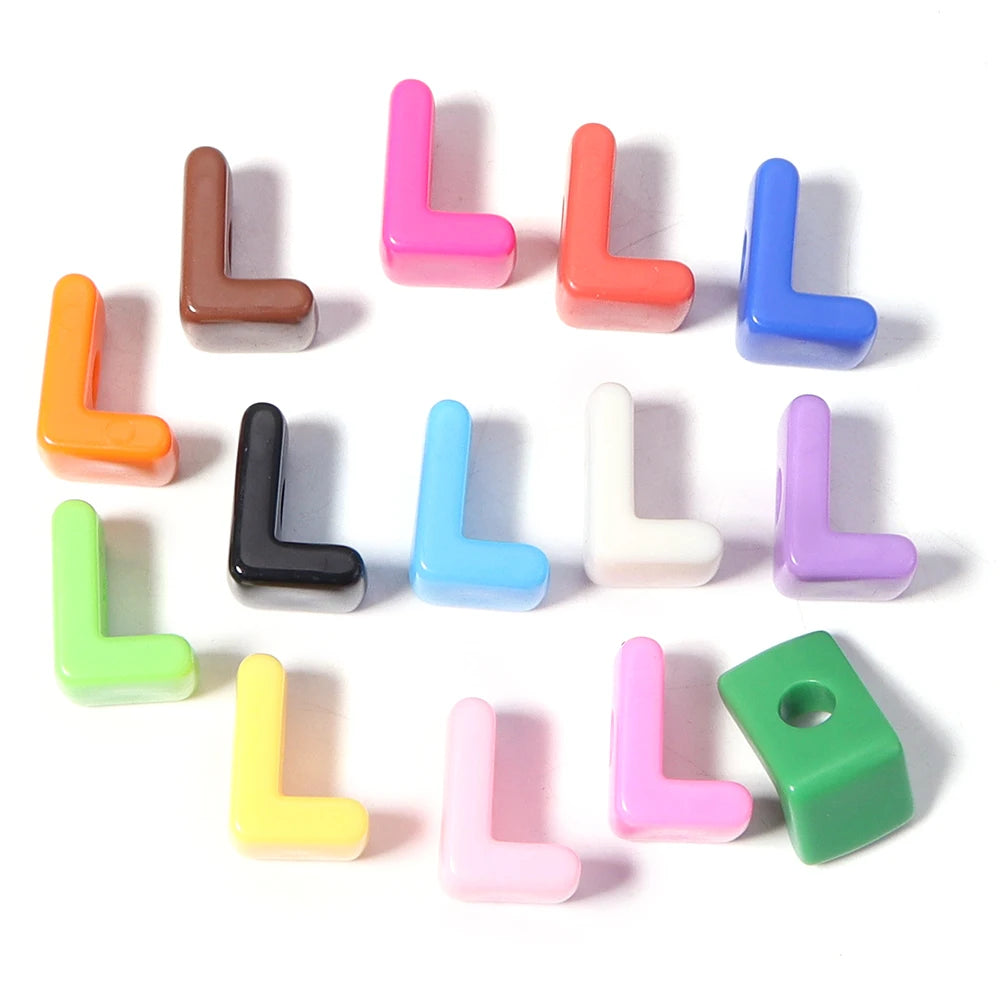 A collection of colorful acrylic letter beads in various shades including pink, orange, blue, and green.