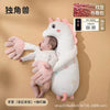 A white unicorn plush toy designed as a soothing pillow for babies, with pink accents and star details.