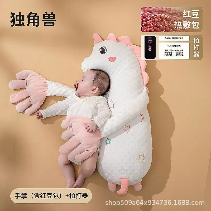 A white unicorn plush toy designed as a soothing pillow for babies, with pink accents and star details.