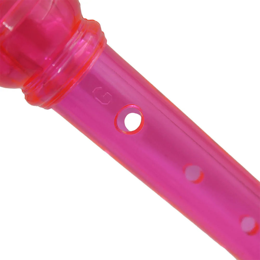 Close-up view of a pink transparent ABS recorder with an eight-hole woodwind flute design.