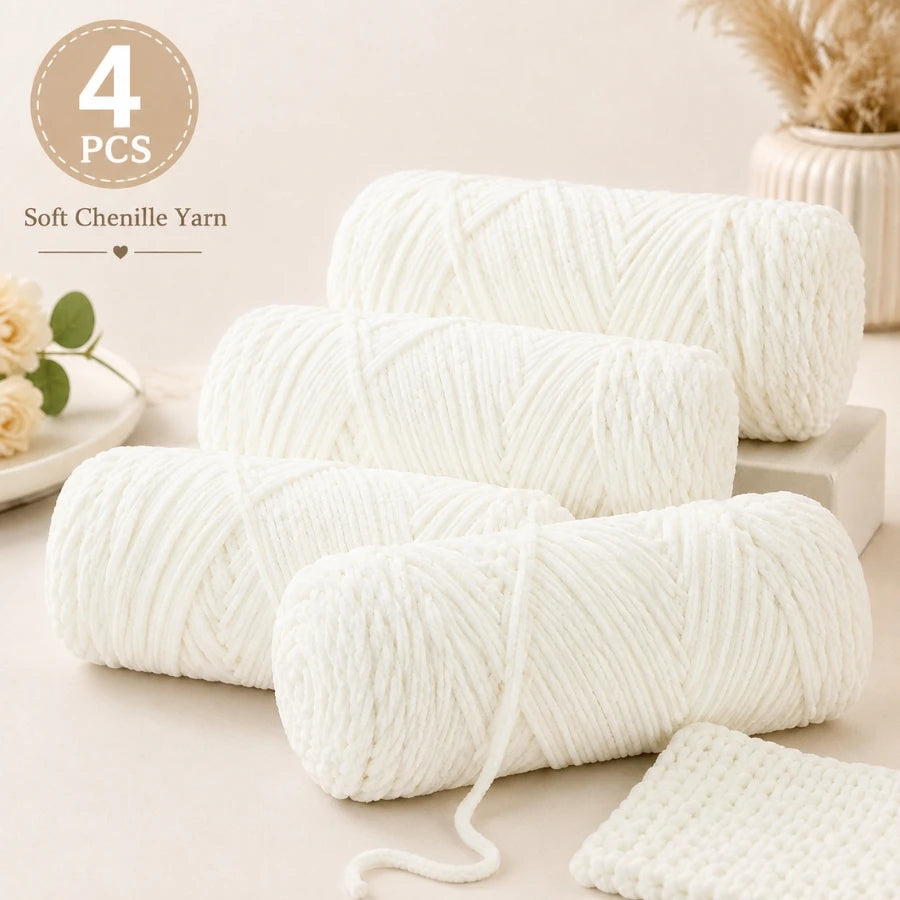 Four skeins of white soft chenille yarn for crochet and knitting displayed on a light surface.