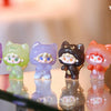 A collection of pastel-colored cat mini figurines in various shades including green, purple, black, and pink.