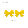 A pair of yellow silicone bow tie beads for jewelry making and craft projects.